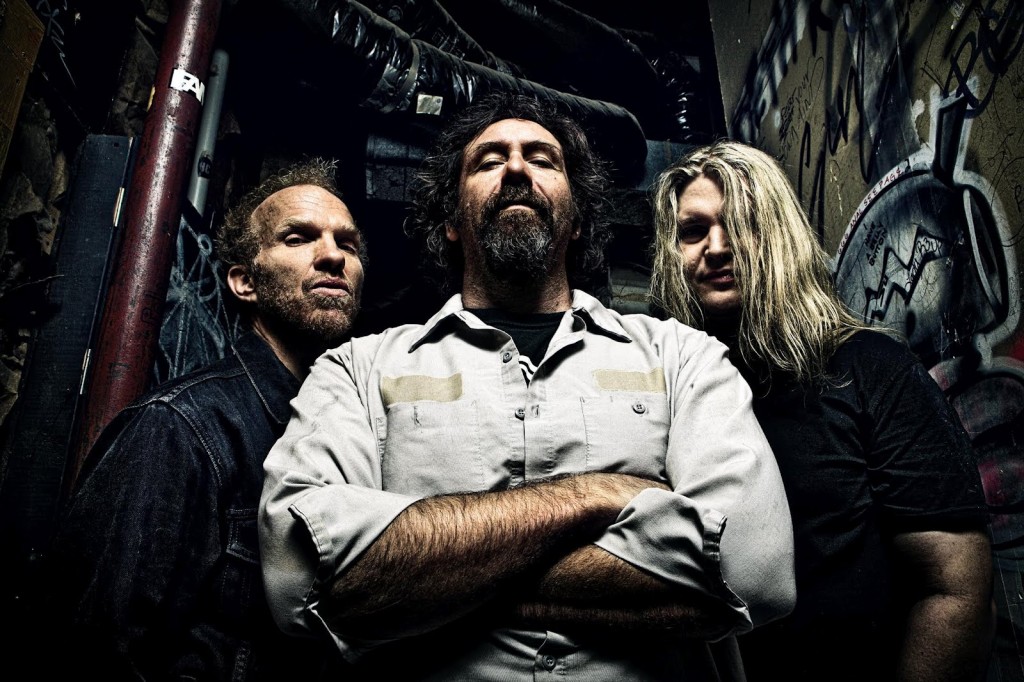 Corrosion of Conformity is:   Mike Dean – bass, vocals;  Woodroe Weatherman – guitar; Reed Mullin – drums, vocals